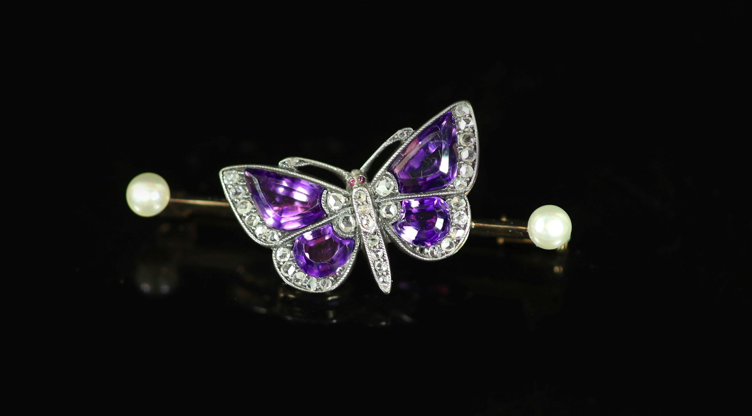 An early 20th century gold, shaped amethyst, rose cut diamond and two stone pearl set butterfly bar brooch